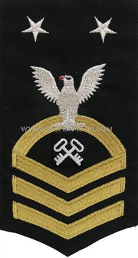 US Navy E9 Storekeeper Blue Rating Badge.Worn on the left sleeve of Dinner Dress Blue and the Navy Dress Blue uniform .All Rating Badges are made to military specifications.